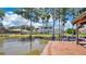 Stunning waterfront view showcasing the home's backyard, boat dock, and lakeside charm at 26516 Savage Cir, Howey In The Hills, FL 34737