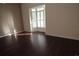Bright bedroom featuring hardwood floors and a large bay window with shutter-style blinds at 292 Nautica Mile Dr, Clermont, FL 34711