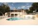 Resort-style pool with ample lounge seating and a charming two-story building with a fenced in surrounding at 292 Nautica Mile Dr, Clermont, FL 34711