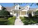 Charming home featuring a covered porch, manicured lawn, and neatly trimmed hedges for enhanced curb appeal at 292 Nautica Mile Dr, Clermont, FL 34711