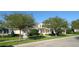 Inviting home with a covered porch, complemented by mature trees and well-maintained landscaping at 292 Nautica Mile Dr, Clermont, FL 34711