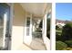 Inviting covered porch featuring white columns and railing, with views of the neighborhood at 292 Nautica Mile Dr, Clermont, FL 34711