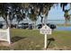 Scenic private beach entrance with lush greenery and waterfront views, showcasing boat docks at 292 Nautica Mile Dr, Clermont, FL 34711