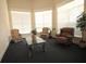 Relaxing seating area with comfortable armchairs, a glass table, and bright natural light filtering through the windows at 292 Nautica Mile Dr, Clermont, FL 34711