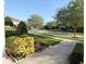 Scenic street view with lush landscaping and mature trees lining the sidewalk on a bright, sunny day at 292 Nautica Mile Dr, Clermont, FL 34711