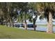 Picturesque waterfront view with lush trees and boat docks, creating a serene and inviting atmosphere at 292 Nautica Mile Dr, Clermont, FL 34711