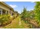 View of the home's backyard with a brick pathway and lush landscaping at 2928 Delaney St, Orlando, FL 32806