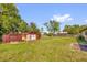 Spacious backyard featuring green grass and two storage sheds at 2928 Delaney St, Orlando, FL 32806