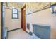 Vintage bathroom featuring blue fixtures, tiled walls, patterned wallpaper, and a window for natural light at 2928 Delaney St, Orlando, FL 32806
