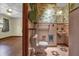 Vintage pink bathroom with patterned wallpaper and shelves, blending retro charm at 2928 Delaney St, Orlando, FL 32806
