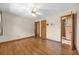 Spacious bedroom with a ceiling fan and wood floors, leading to the bathroom at 2928 Delaney St, Orlando, FL 32806
