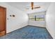 Bedroom with a window that allows natural light and vintage carpet flooring at 2928 Delaney St, Orlando, FL 32806