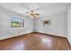 Bright bedroom featuring hardwood floors, natural light, and a ceiling fan at 2928 Delaney St, Orlando, FL 32806