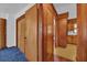 Hallway with wood paneling and a view into the kitchen at 2928 Delaney St, Orlando, FL 32806