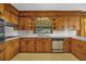 Kitchen with vintage knotty pine cabinetry, ample storage and light countertops at 2928 Delaney St, Orlando, FL 32806