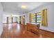 Living room featuring hardwood floors, ample natural light, and a ceiling fan, perfect for entertaining at 2928 Delaney St, Orlando, FL 32806