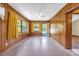 Living room with wood walls, natural light, and ceiling fan at 2928 Delaney St, Orlando, FL 32806