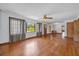 Spacious living room with hardwood floors, multiple windows, and a ceiling fan, creating a cozy atmosphere at 2928 Delaney St, Orlando, FL 32806