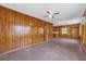 Large living room with wood paneling and ceiling fan at 2928 Delaney St, Orlando, FL 32806