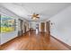 Inviting living room with polished hardwood floors, bright windows, and classic ceiling fan at 2928 Delaney St, Orlando, FL 32806