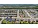 Neighborhood aerial view showing the home's location among tree-lined streets and similar residences at 3002 Bethpage Loop, Mount Dora, FL 32757
