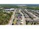 This aerial view showcases this neighborhood with well-maintained lawns, backyard pools, and proximity to green spaces at 3002 Bethpage Loop, Mount Dora, FL 32757