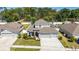 Beautiful two-story home with a large driveway, attached two car garage, and well-maintained lawn at 3002 Bethpage Loop, Mount Dora, FL 32757