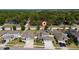 A beautiful aerial view of a gray house with well maintained landscaping and a nice yard at 3002 Bethpage Loop, Mount Dora, FL 32757