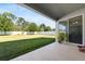 Inviting back patio showcasing a spacious, green fenced-in yard at 3002 Bethpage Loop, Mount Dora, FL 32757