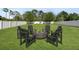 Outdoor backyard features a fire pit and Adirondack chairs, perfect for entertaining in the Florida weather at 3002 Bethpage Loop, Mount Dora, FL 32757