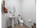 Small bathroom featuring a white sink, toilet, and neutral wall color at 3002 Bethpage Loop, Mount Dora, FL 32757