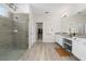 Bright bathroom featuring a glass shower, wood-style floors, and white vanity at 3002 Bethpage Loop, Mount Dora, FL 32757