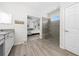 A bathroom featuring a walk-in shower with a view into the bedroom at 3002 Bethpage Loop, Mount Dora, FL 32757