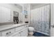 Clean bathroom featuring a white vanity with a solid surface countertop, a toilet, and a shower-tub combo at 3002 Bethpage Loop, Mount Dora, FL 32757