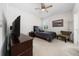 Bedroom featuring a dark bed, a ceiling fan, neutral decor, and a small window, creating a serene space at 3002 Bethpage Loop, Mount Dora, FL 32757