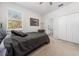 Comfortable bedroom featuring a neutral-colored queen bed, a ceiling fan, and an ensuite bathroom access at 3002 Bethpage Loop, Mount Dora, FL 32757