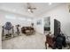 Bonus room with a ceiling fan, comfortable seating, exercise bike, and an open doorway to a bedroom at 3002 Bethpage Loop, Mount Dora, FL 32757