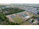 An aerial view of community sports courts featuring basketball, tennis, and volleyball at 3002 Bethpage Loop, Mount Dora, FL 32757