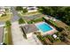 A birds eye view of a community pool featuring beautiful landscaping and mature trees at 3002 Bethpage Loop, Mount Dora, FL 32757