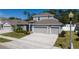 Well-maintained two-story home features a two car garage, well-manicured lawn, and tasteful landscaping at 3002 Bethpage Loop, Mount Dora, FL 32757