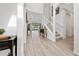 Inviting foyer with tile floors, soaring ceilings, staircase, and a view of the living room at 3002 Bethpage Loop, Mount Dora, FL 32757