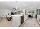 An open-concept kitchen with a large center island and views of the living area at 3002 Bethpage Loop, Mount Dora, FL 32757