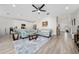 A spacious living area with a light-colored sofa, tile floors, and natural light at 3002 Bethpage Loop, Mount Dora, FL 32757