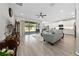 An open-concept living room with tile flooring, large sliding doors, and neutral decor at 3002 Bethpage Loop, Mount Dora, FL 32757