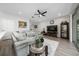 Cozy living room with tile floors, modern decor, and access to the kitchen at 3002 Bethpage Loop, Mount Dora, FL 32757