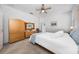 Bright bedroom featuring neutral walls, plush carpet, and a comfortable king-sized bed at 3002 Bethpage Loop, Mount Dora, FL 32757