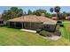 A lovely home features a screened lanai, brick exterior, and well-maintained lawn at 301 Waterwood Dr, Yalaha, FL 34797
