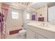 Cozy bathroom with a combined shower and tub, complemented by a bright vanity and stylish mirror at 301 Waterwood Dr, Yalaha, FL 34797