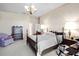 Comfortable bedroom featuring a decorative chandelier and a large window for ample natural light at 301 Waterwood Dr, Yalaha, FL 34797