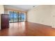Bright bedroom with beautiful hardwood floors and sliding glass doors with waterfront views at 301 Waterwood Dr, Yalaha, FL 34797
